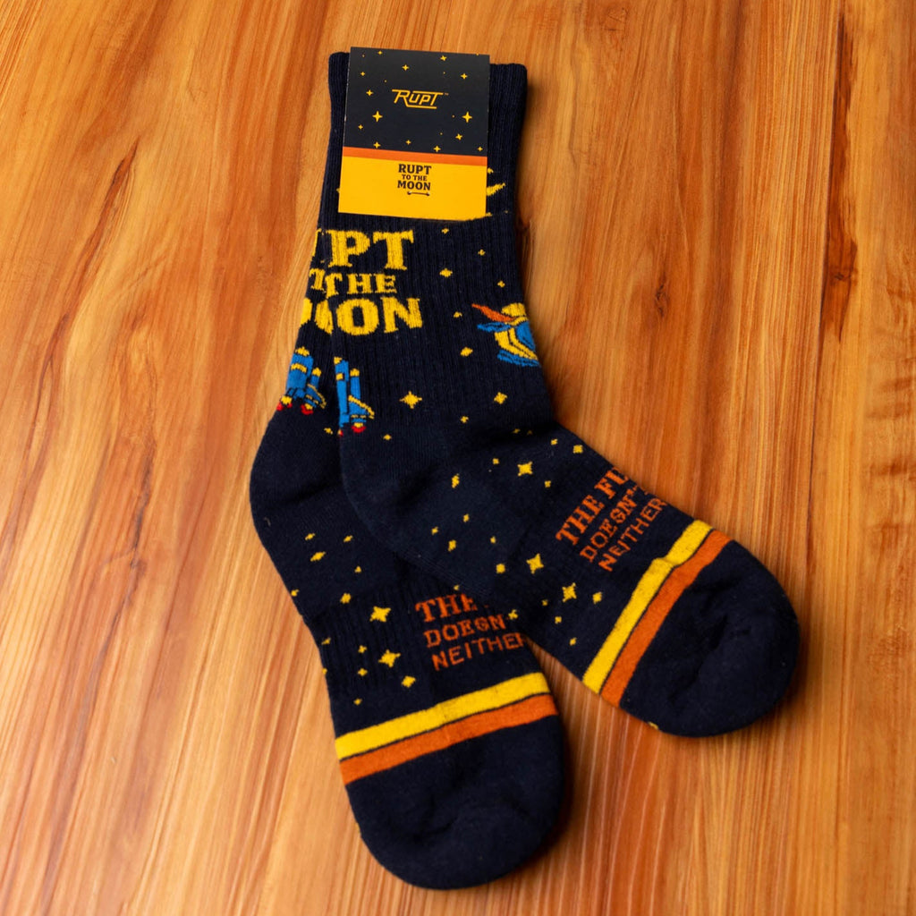 Pair of socks with text and graphics on a wooden surface